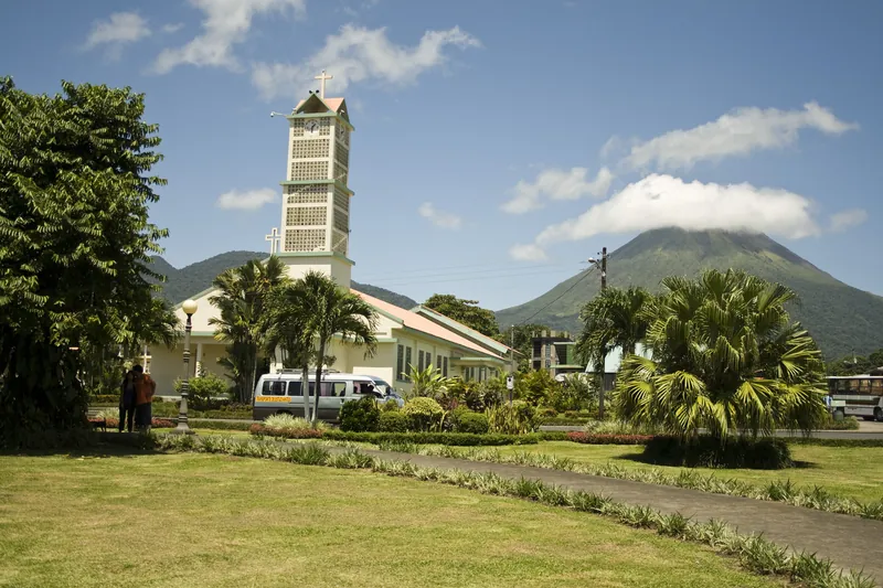 The park and church in La Fortuna, with Arenal behind